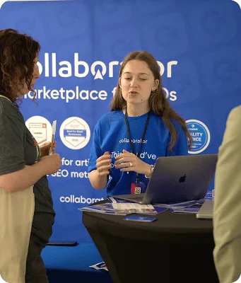 Член команды Collaborator общается с посетителем у стенда на Croatia SEO Summit.